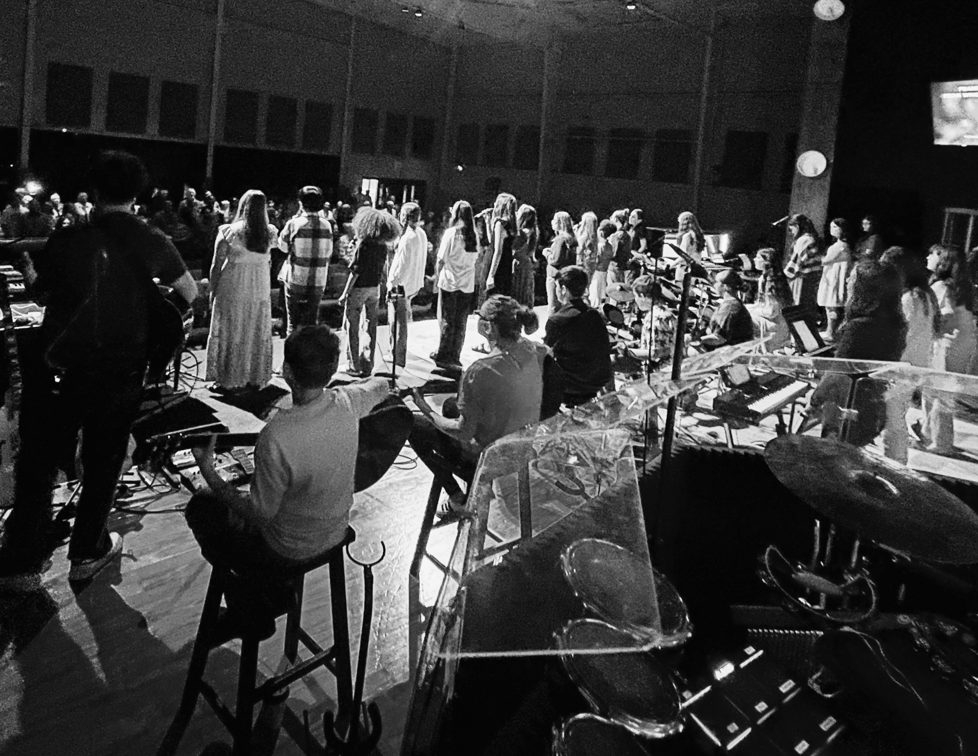 Students worshipping together, arms around each other